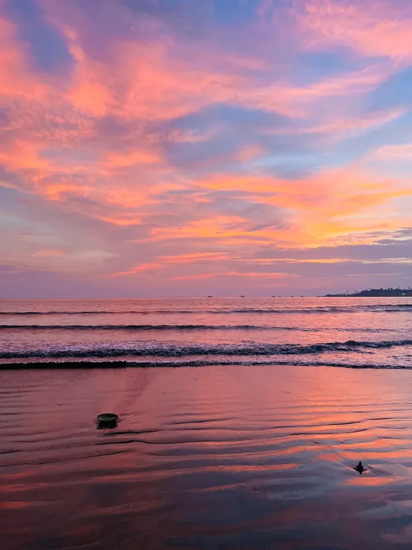Pink sunset reflected on the beach
